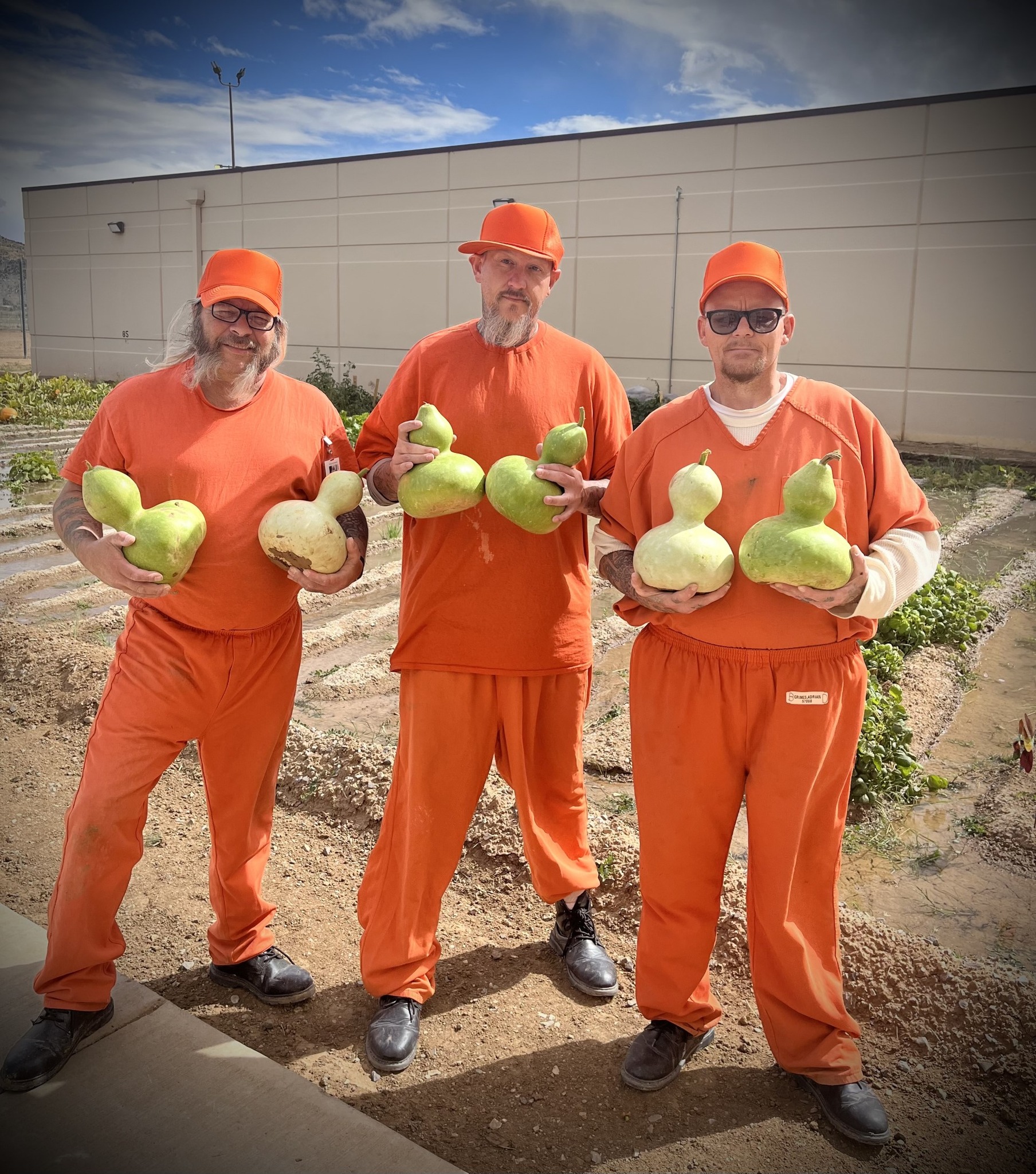 Inmates holding their harvest from the garden