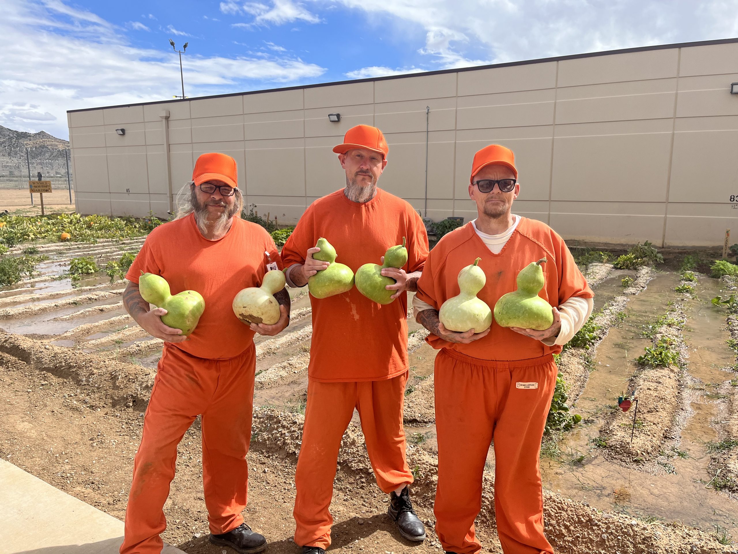 Inmates holding their harvest from the facility garden