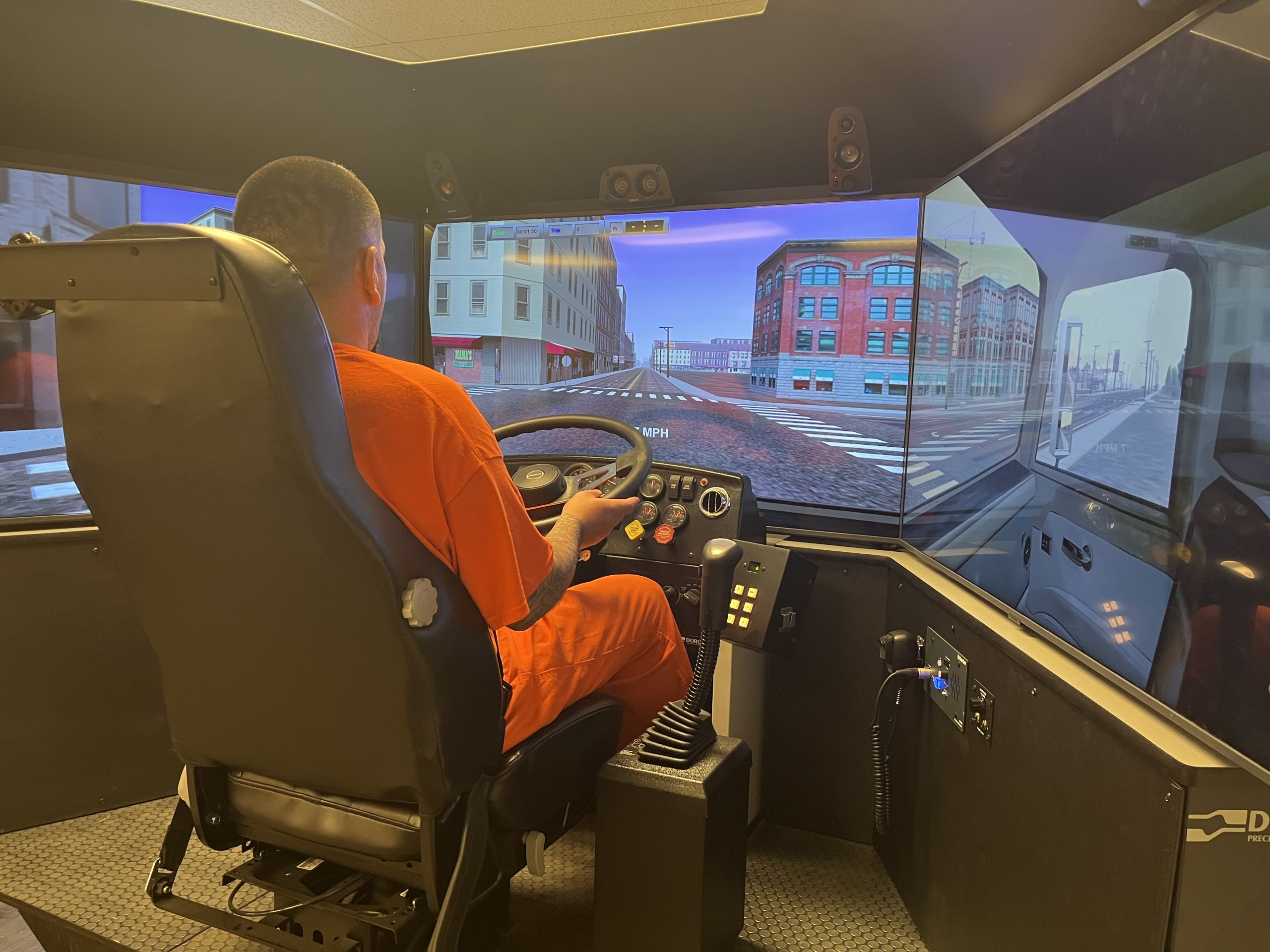 Inmate in a semi-truck driving simulator