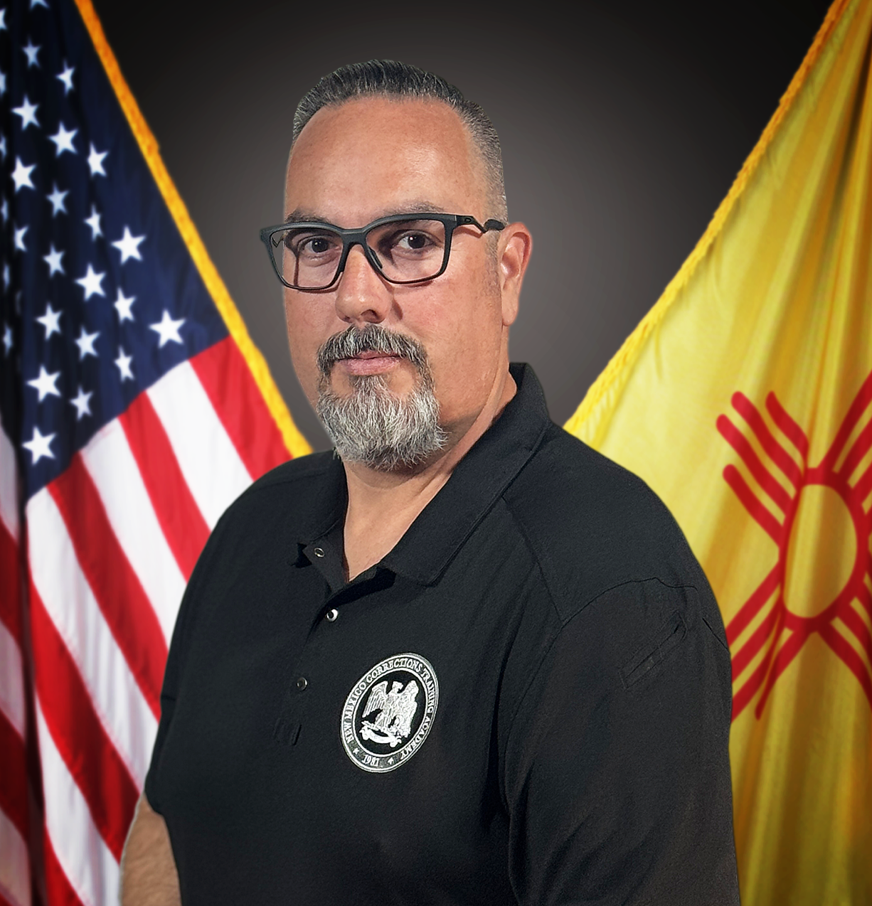 David Gonzales 4x4 Headshot of anonymous person against United States flag and New Mexico flag background